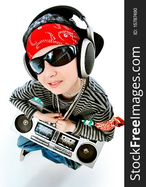 Shot of a trendy teenager listening to music in headphones. Isolated over white background.