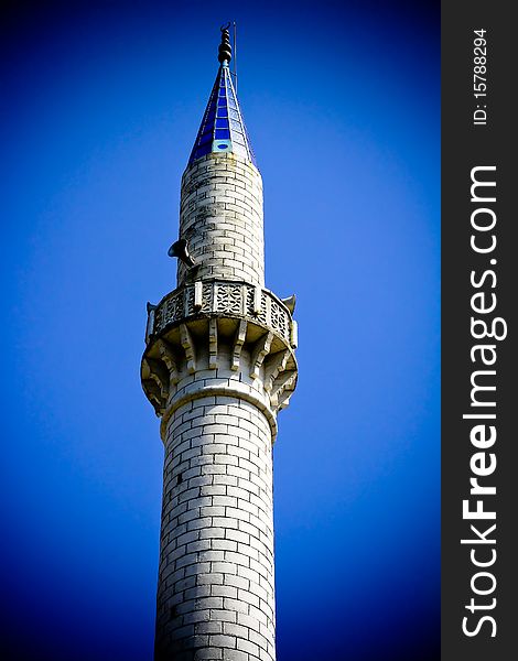 Mosque set against blue sky with vignette