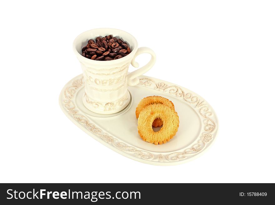 Cup of coffee beans with cakes isolated on white. Cup of coffee beans with cakes isolated on white