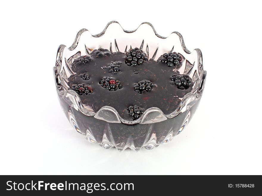 Compote of blackberries in glass bowl isolated on white