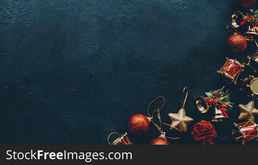 Winter holidays greeting card. Cropped flat lay of Christmas ornaments on dark teal blue background. Copy space. Winter holidays greeting card. Cropped flat lay of Christmas ornaments on dark teal blue background. Copy space.