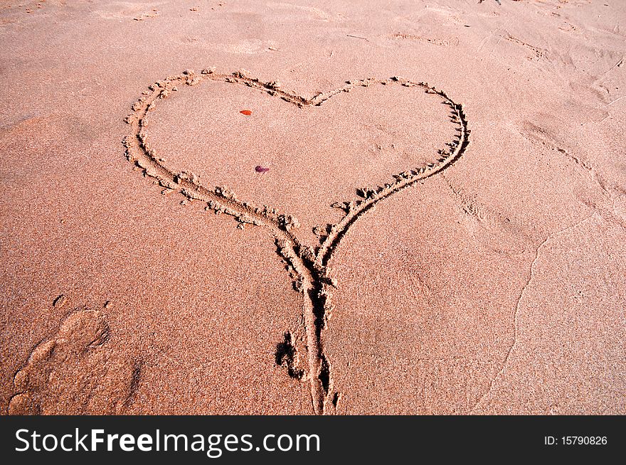Heart written in the sand