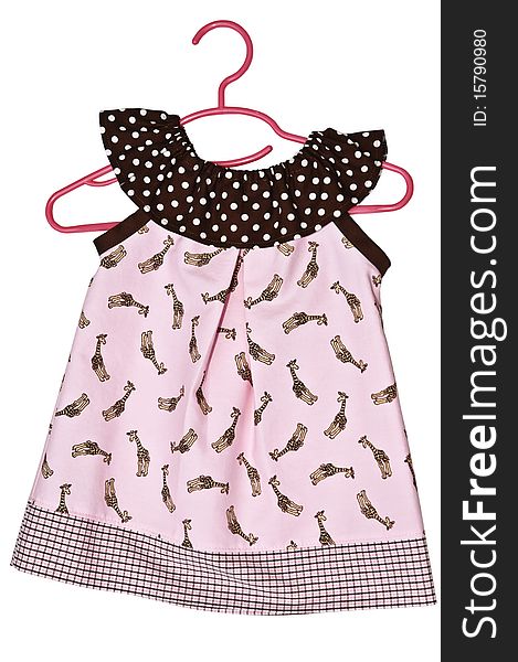 A child's cute pink dress, with a giraffe design, on a hanger. A child's cute pink dress, with a giraffe design, on a hanger.