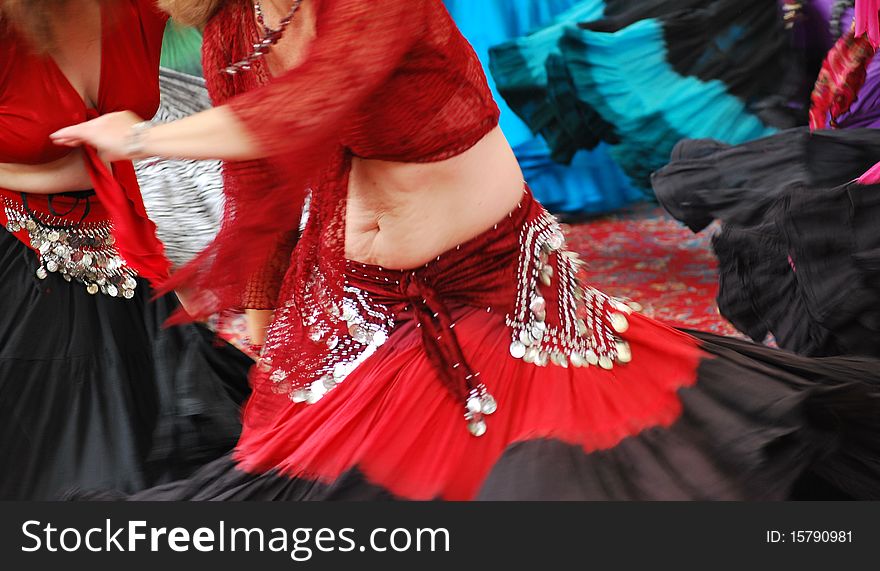 Belly dancers performing to music in motion on stage. Belly dancers performing to music in motion on stage.