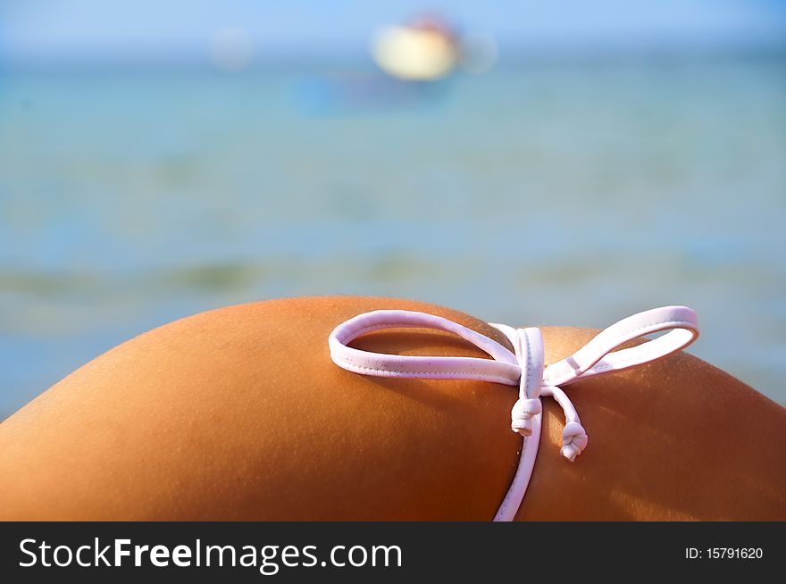 Side Of Girl On The Beach With Costumes