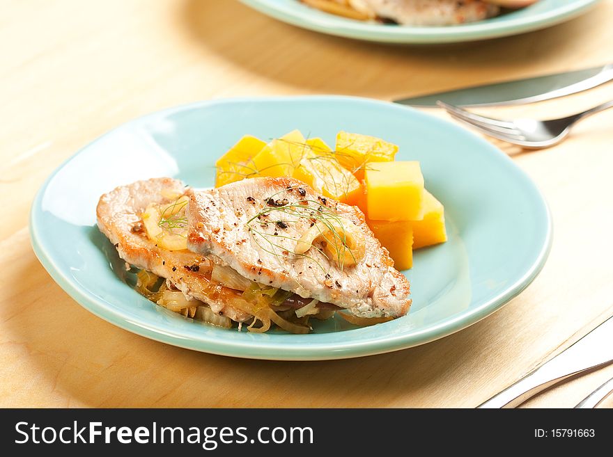 Thin pork chops with apple and fennel accompanied by butternut squash and rutabaga. Thin pork chops with apple and fennel accompanied by butternut squash and rutabaga