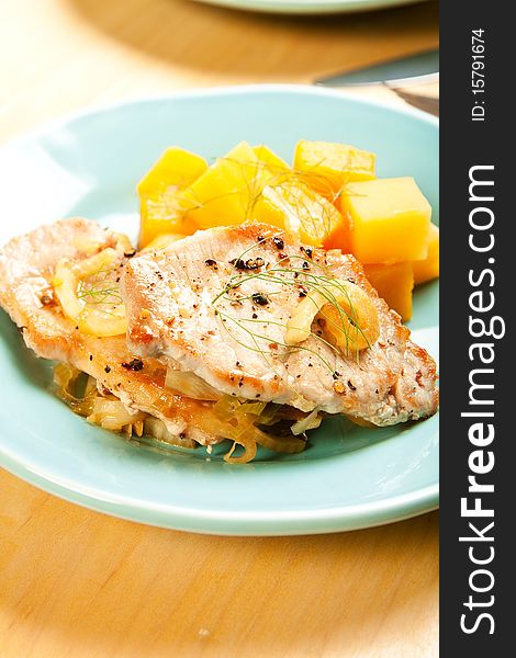 Thin pork chops with apple and fennel accompanied by butternut squash and rutabaga. Thin pork chops with apple and fennel accompanied by butternut squash and rutabaga