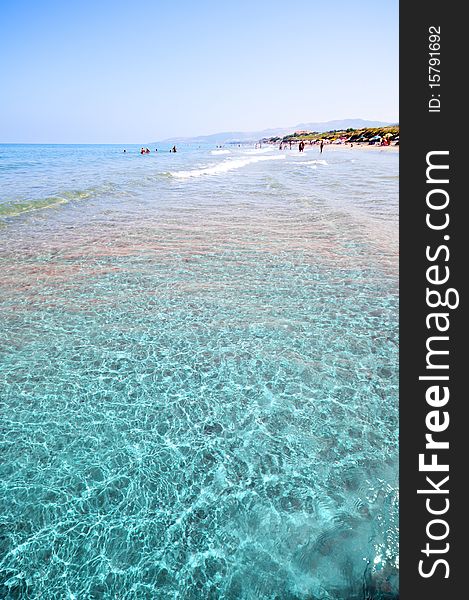 Seashore with waves and foam and blue sky