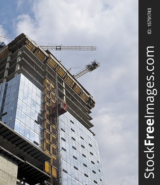 Condominium tower under construction with cranes. Condominium tower under construction with cranes