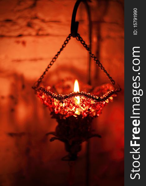 Red candle light hanging on iron case