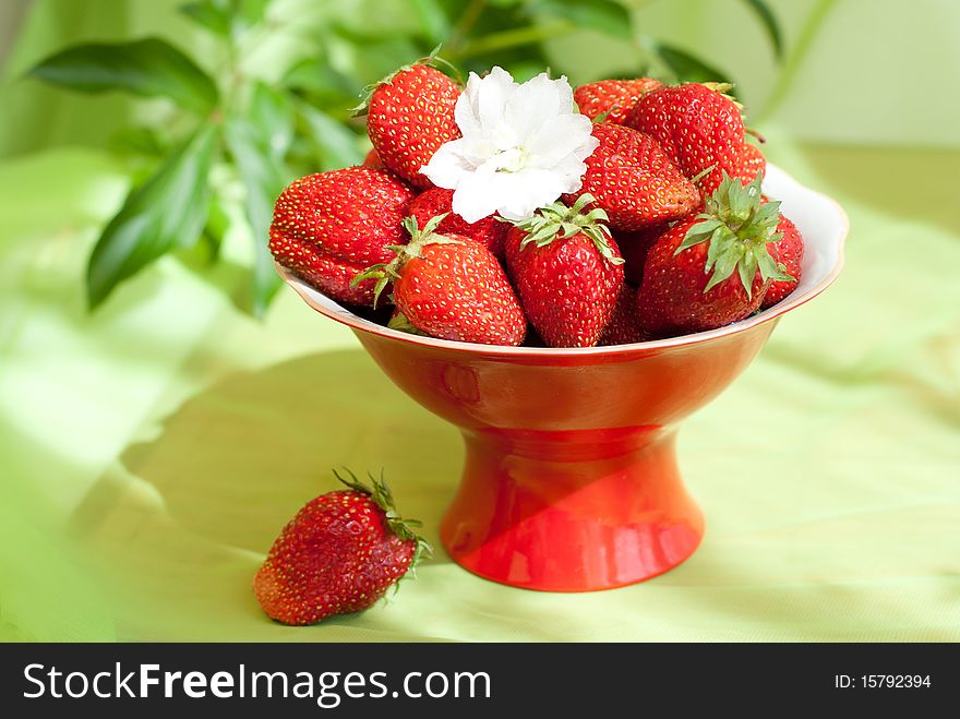 Delicious ripe strawberries on the red plate