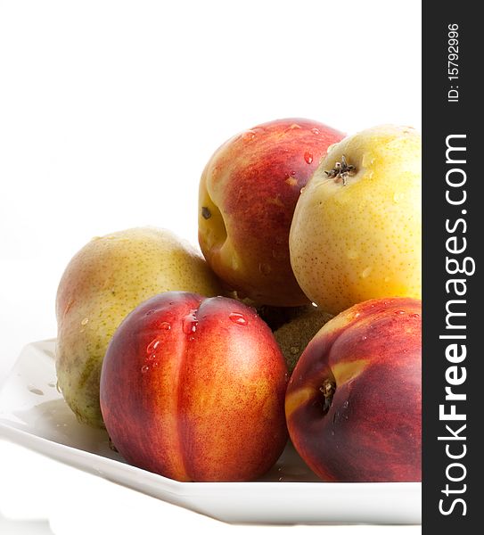 Pears and apricots against a white background. Pears and apricots against a white background
