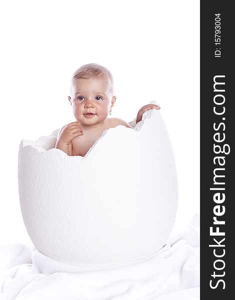 Baby girl in egg on white background