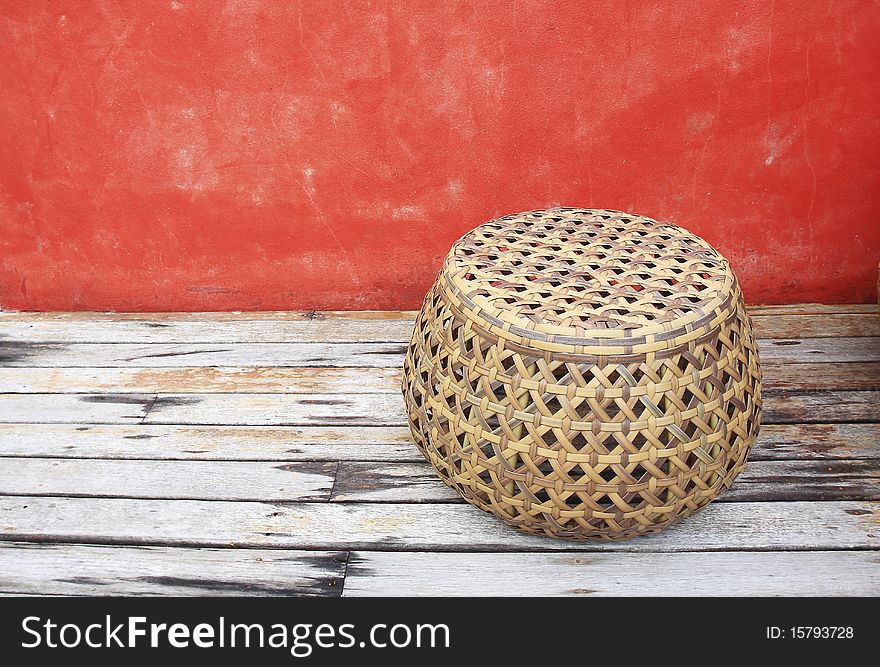Rattan Chairs With Red Walls On Old Wood