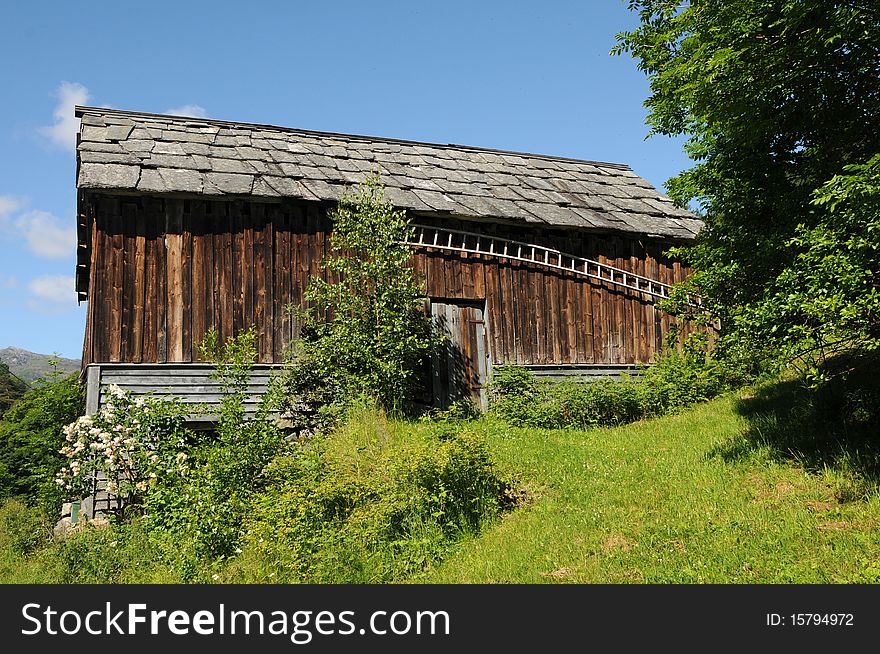 Farm hut amidst orchards and fields above Hardangerfjord, Norway. Farm hut amidst orchards and fields above Hardangerfjord, Norway