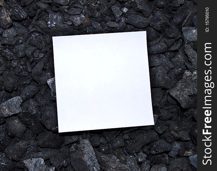 Sheet of paper on coal background