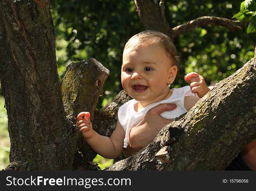 Baby near a tree enjoying the nature. Baby near a tree enjoying the nature