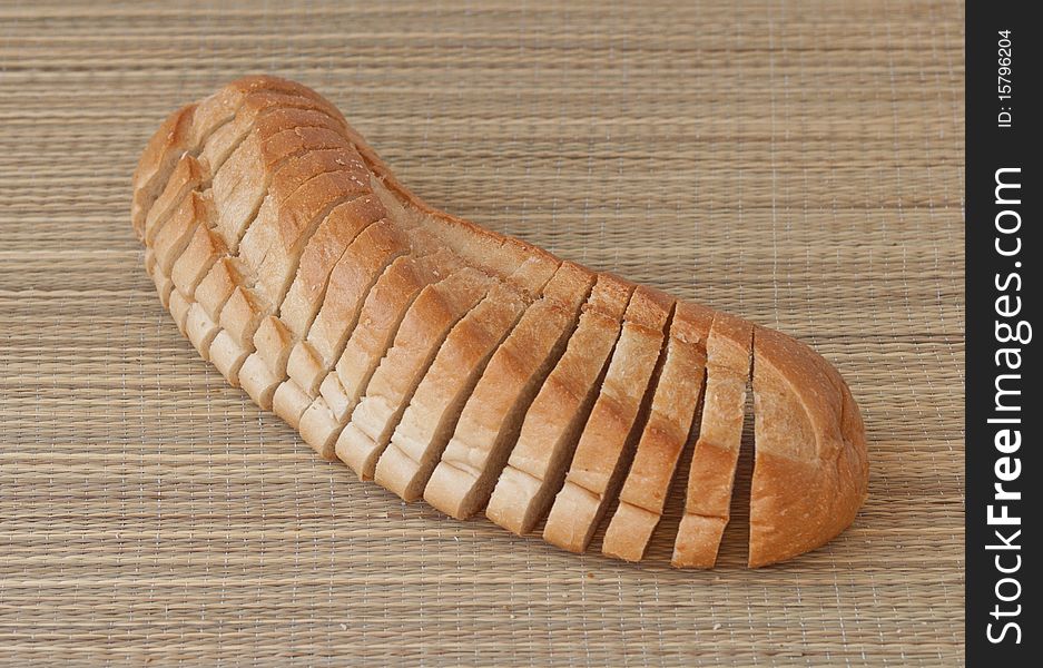 Bread sliced on a bamboo mat