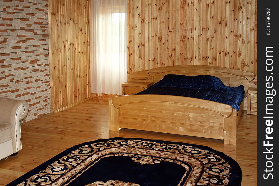 Interior with wooden bed, walls and floor. Interior with wooden bed, walls and floor