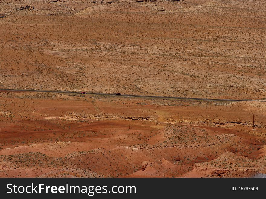 The desert with a road in the distance.