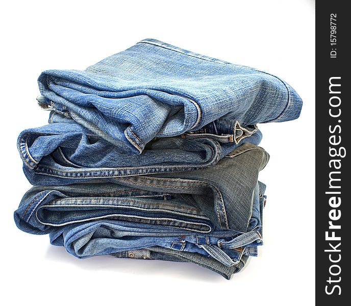Stack of jeans closeup with white background. Stack of jeans closeup with white background