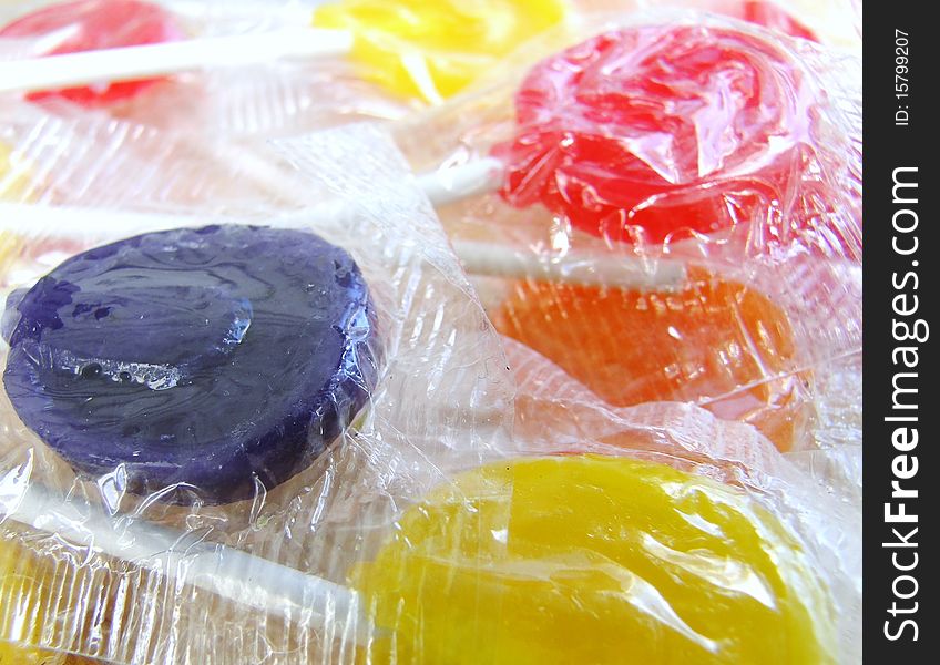 Red, yellow, orange and purple lollipops. Red, yellow, orange and purple lollipops.