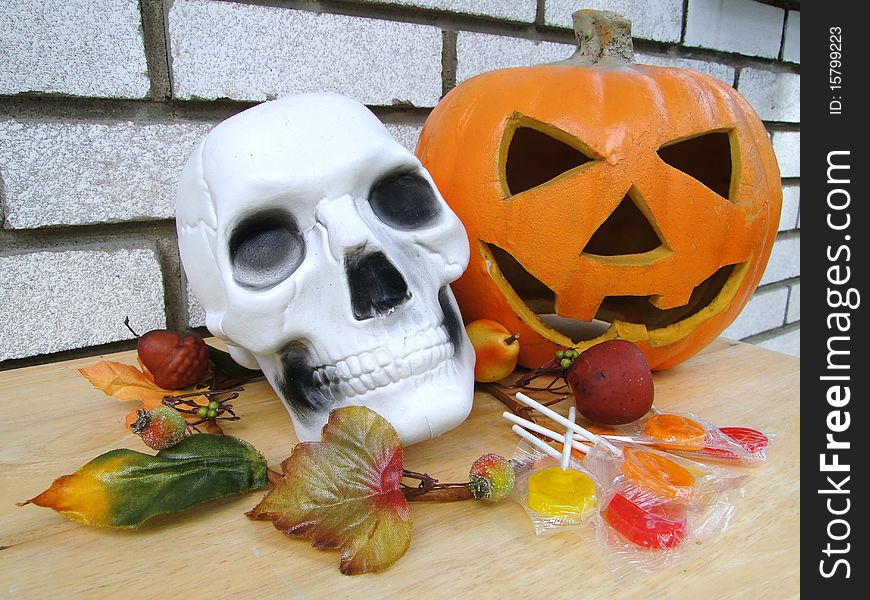 Plastic scull and pumpkin with leafs ornament and candies