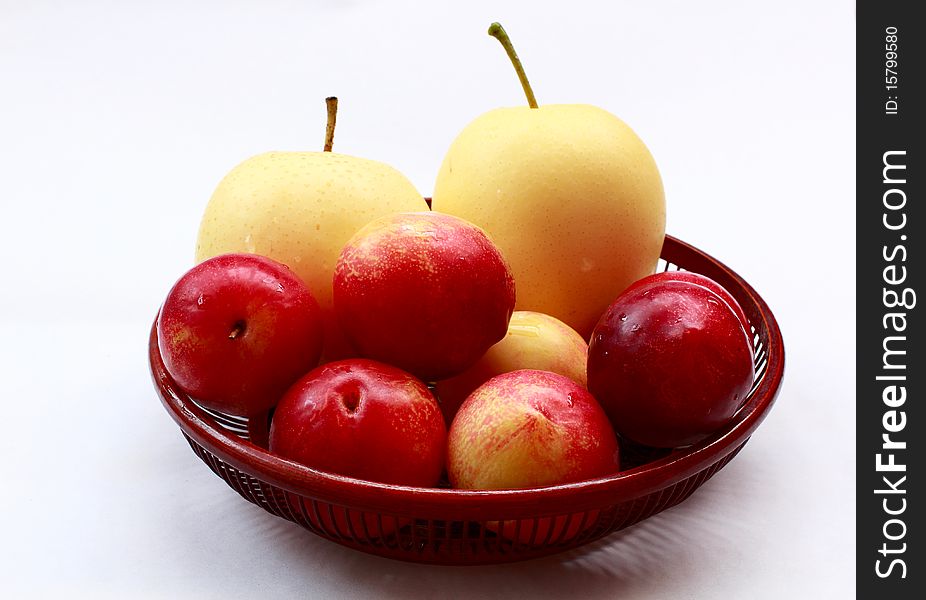 Pears and plums on white backgaund.