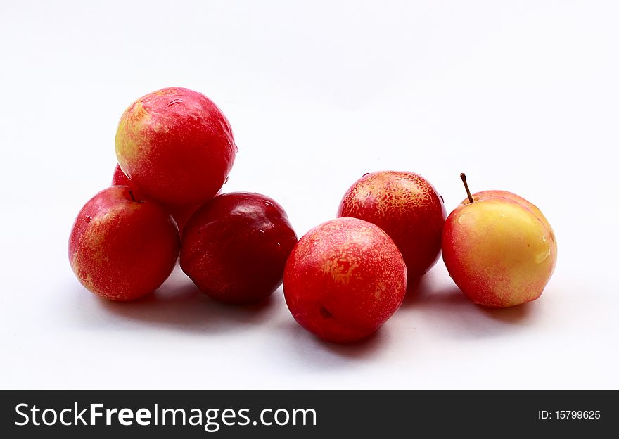 Red plums on white backgrounds.