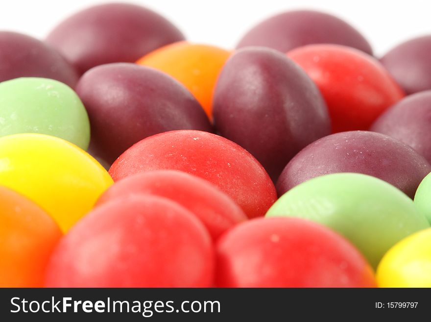 Multicolored candy beans on the white background