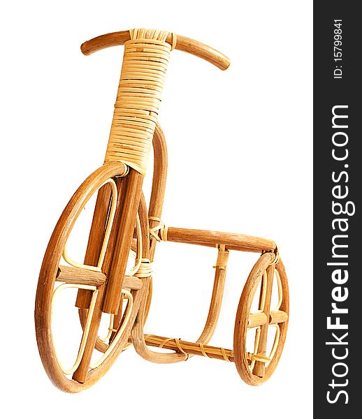 Wooden bicycle. Made by human hands from the dry wood.