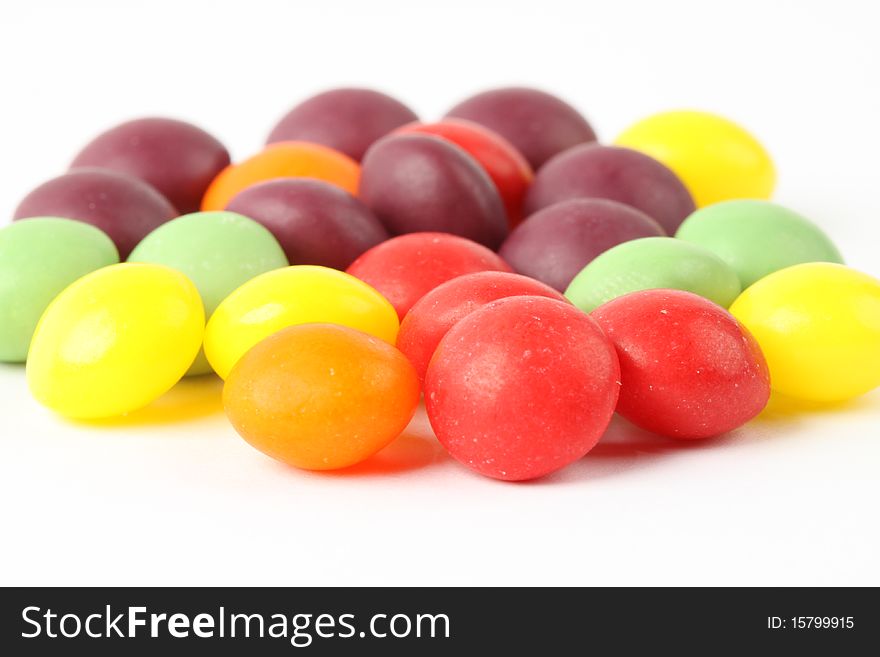 Multicolored candy beans on the white background