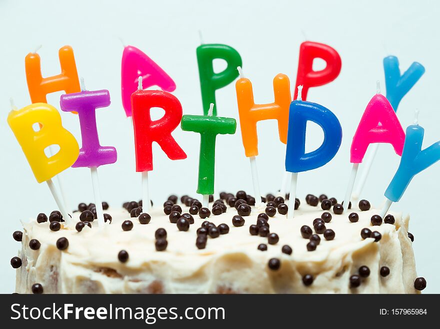 Happy birthday candles on a birthday cake