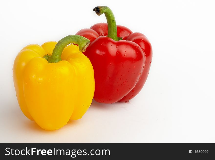 Yellow and red sweet pepper with drops of water