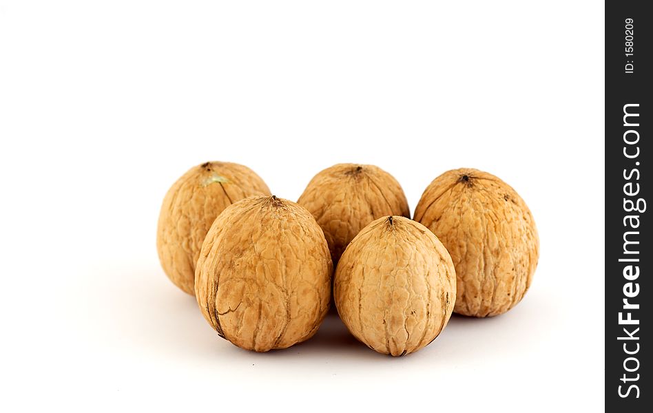 Five walnuts isolated on white