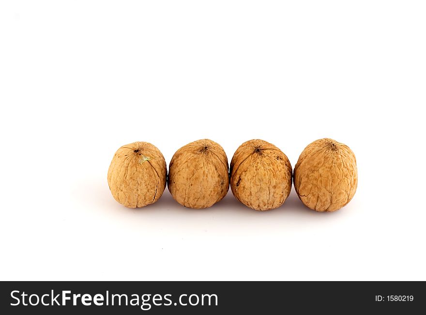 Four walnuts isolated on white background