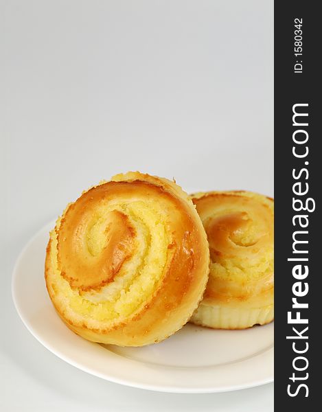 Two Sweet Buns on White Plate. Shallow DOF. Two Sweet Buns on White Plate. Shallow DOF.