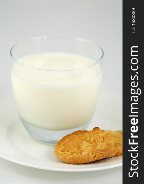 Cookies on White Plate and Glass of Milk. Shallow DOF. Cookies on White Plate and Glass of Milk. Shallow DOF.