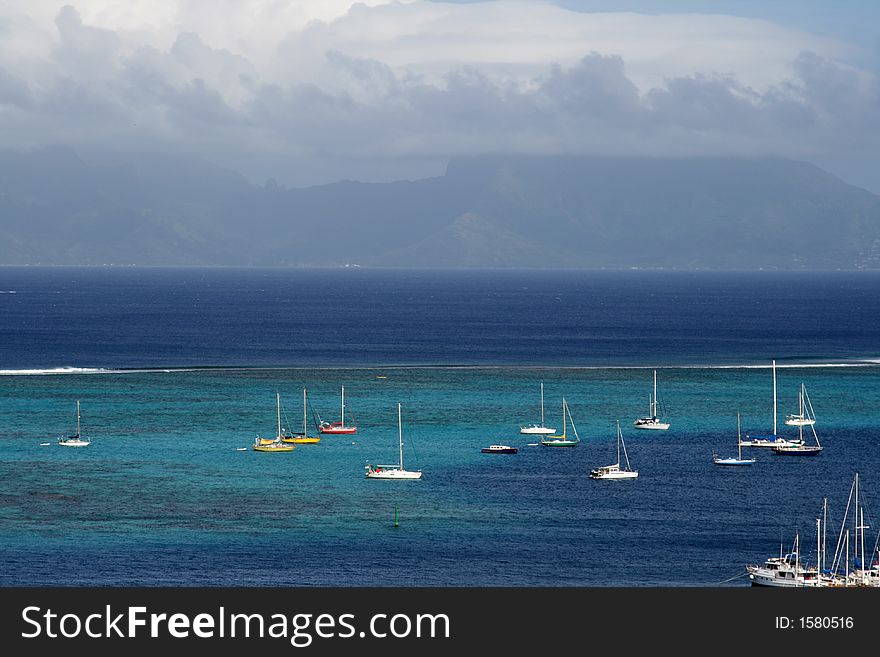 Pacific lagoon with boats at anchor