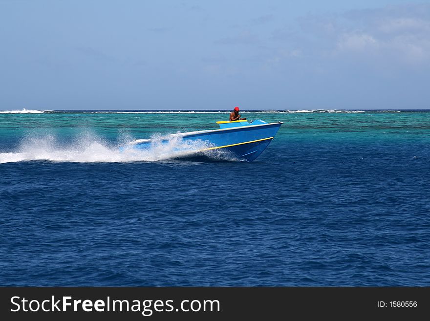 Traditional Tahitian fish boat speeding