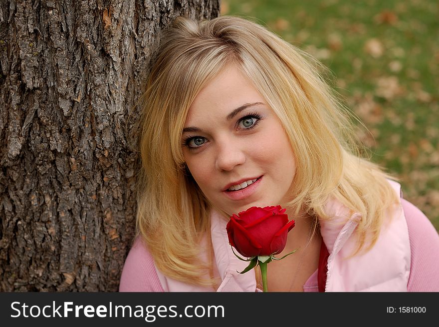 Beautiful young woman holding red rose. Beautiful young woman holding red rose.