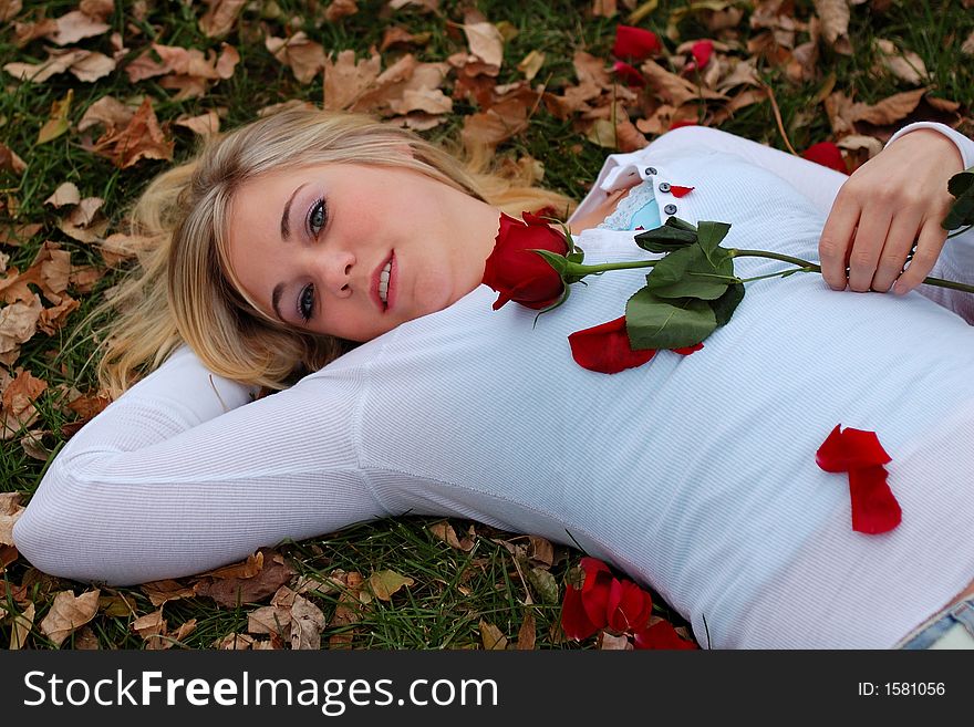 Beautiful young woman holding red rose. Beautiful young woman holding red rose.