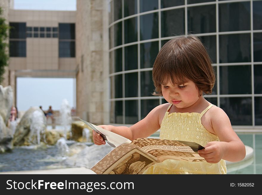 Little girl pretending to read. Little girl pretending to read