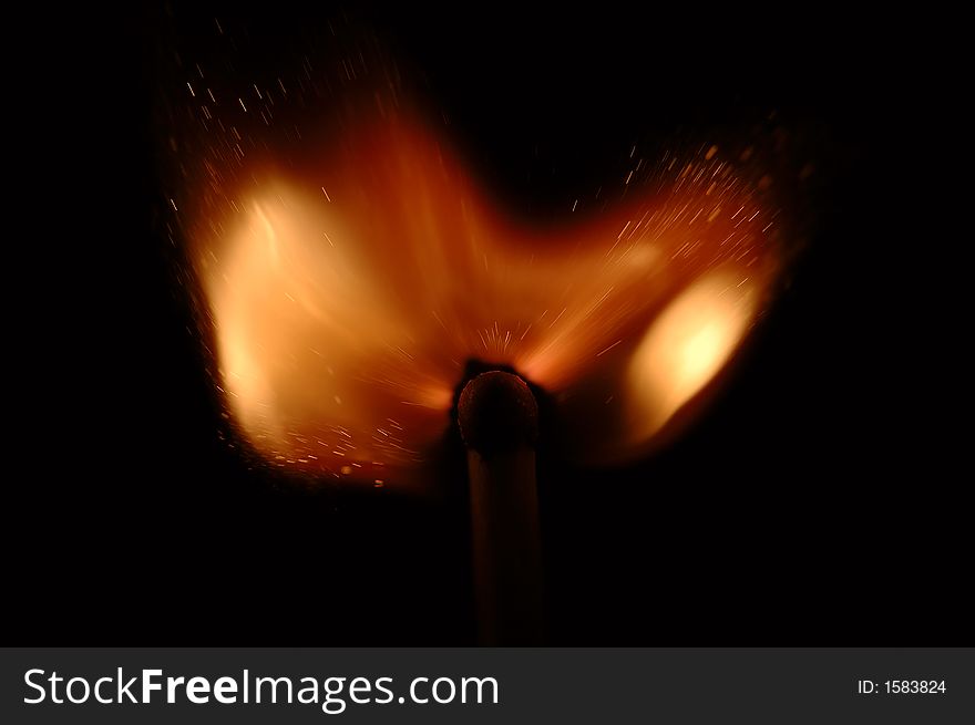 Single match burn on black background, isolated. Single match burn on black background, isolated