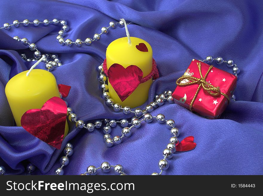 Two valentines yellow candles on a lilac background. Two valentines yellow candles on a lilac background