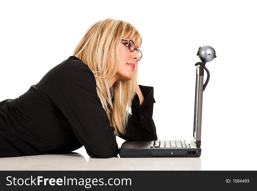 A businesswoman using notebook and webcam