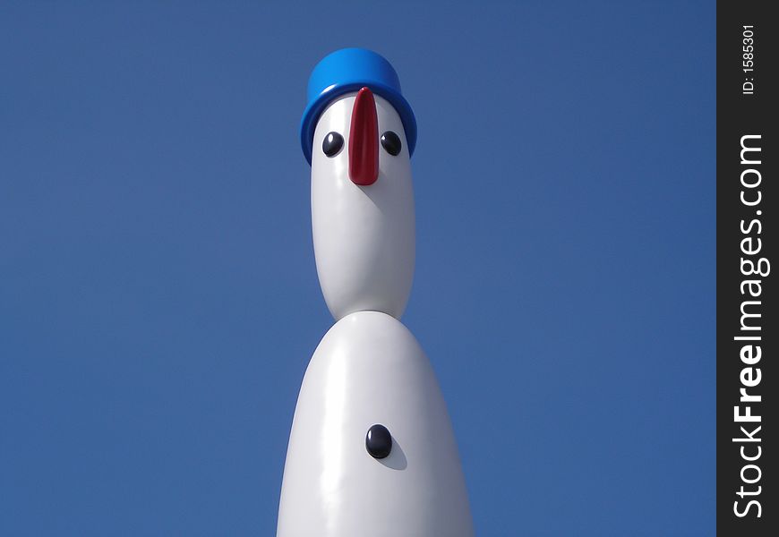 Cute Snowman Against Blue Sky with Copyspace