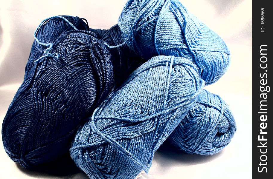 Knitting yarn in blue colors on white background. Knitting yarn in blue colors on white background