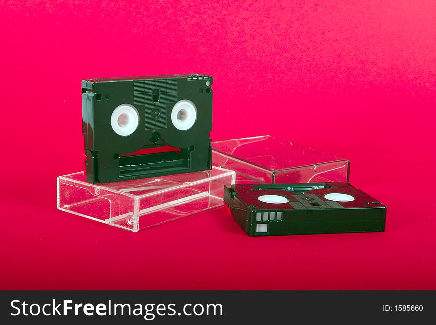 Two mini Digital tapes on the red background. Two mini Digital tapes on the red background