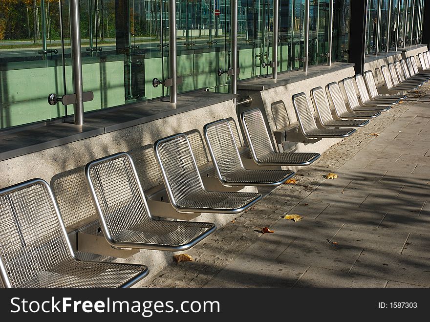 Empty seats closeup, taken at a bus stop in Munich, Germany. Aluminum frames. Empty seats closeup, taken at a bus stop in Munich, Germany. Aluminum frames.